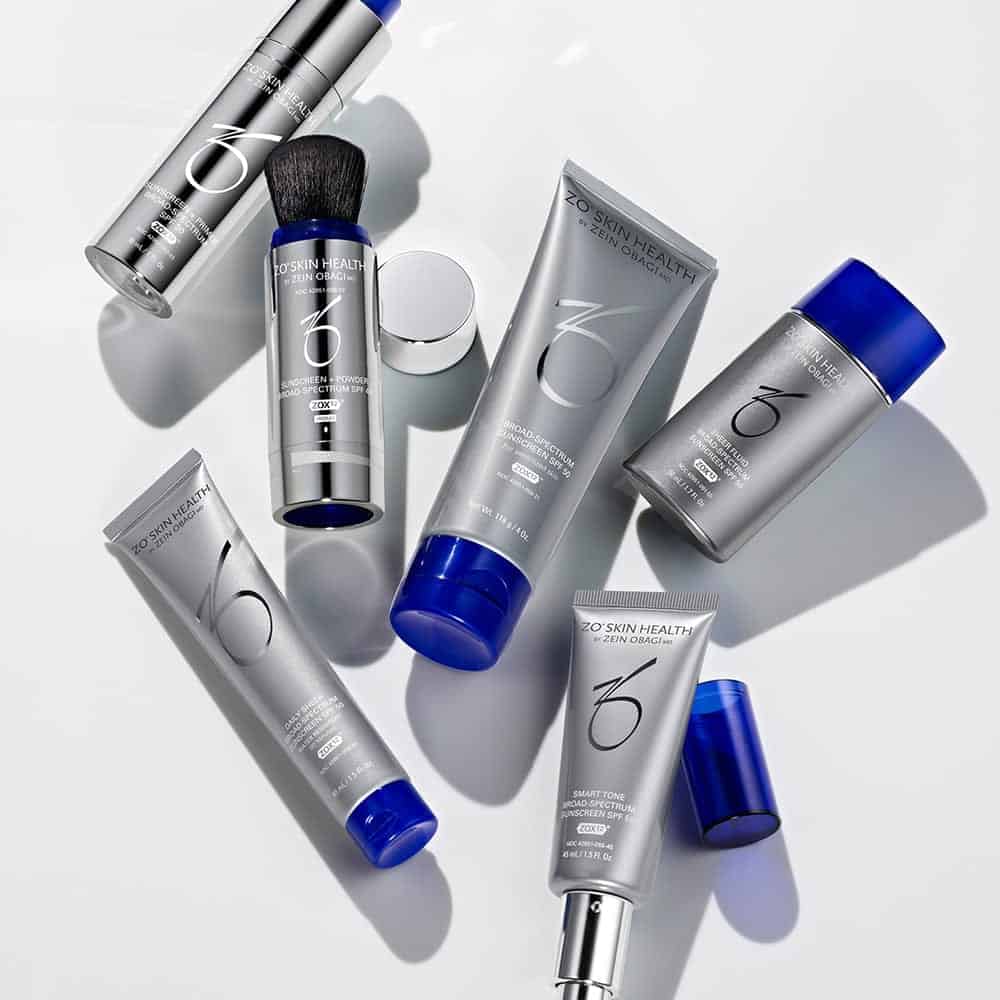 ZO Skin Health products in silver and blue packaging neatly arranged on a white surface.